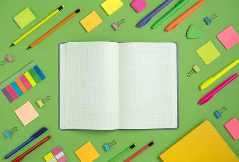Open notebook with space for your text with colorful school and office suppli Stock Photos