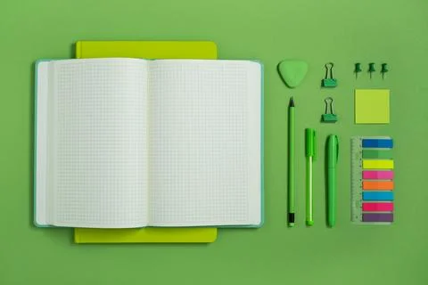 Open notebook with space for your text with green school and office supplies Stock Photos