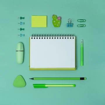 Open notebook with space for your text with green school and office supplies Stock Photos