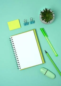 Open notebook with space for your text with green pen, pencil and marker Stock Photos