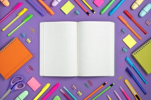 Open notebook with space for your text with colorful school and office suppli Stock Photos