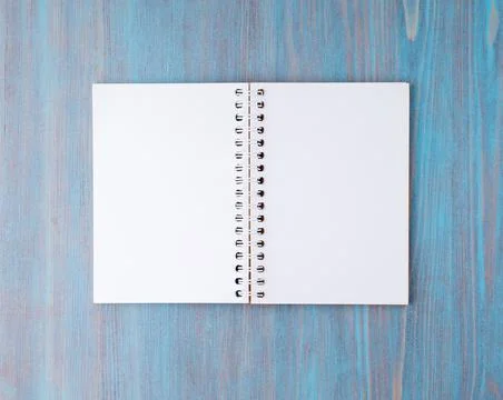 Open notebook on spring with white paper for notes and drawing. Light background Stock Photos