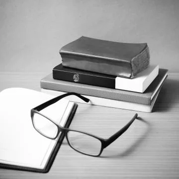 Open notebook with stack of book black and white color tone style Stock Photos