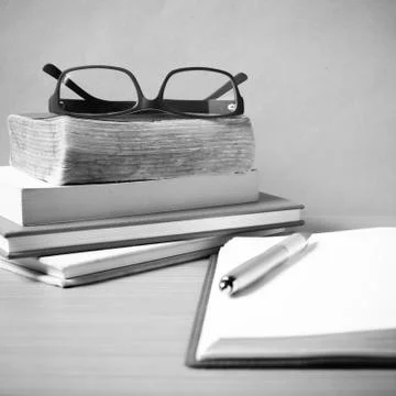 Open notebook with stack of book black and white color tone style Stock Photos