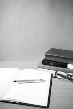Open notebook with stack of book black and white color tone style Stock Photos