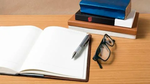 Open notebook with stack of book Stock Photos