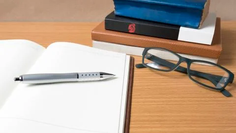 Open notebook with stack of book Stock Photos