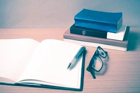 Open notebook with stack of book vintage style Stock Photos