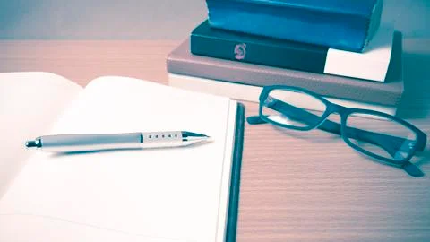 Open notebook with stack of book vintage style Stock Photos