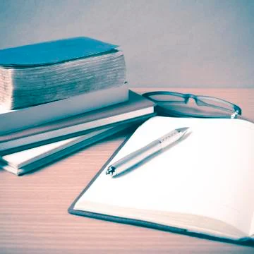 Open notebook with stack of book vintage style Stock Photos