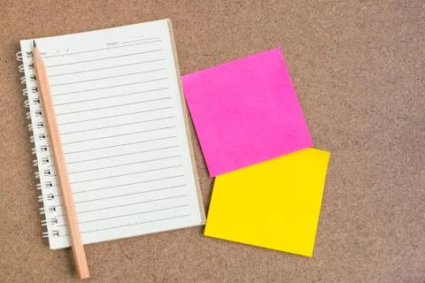 Open notebook with sticky notes on brown background Stock Photos