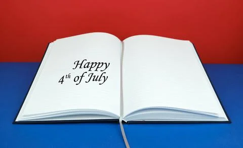Open notebook with the text "Happy 4-th of July" on one page with the blue and r Stock Photos
