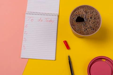 Open notebook with today plans and cup of coffee. Bicolor background Stock Photos
