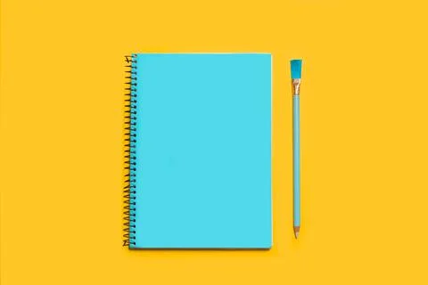 Open notebook in a turquoise page and a turquoise pencil Stock Photos