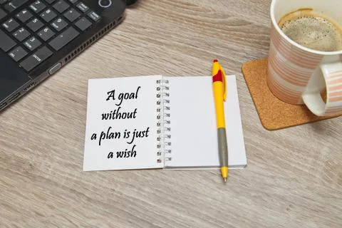 Open notebook with ways to "A goal without plan is just a wish" and a cup of cof Stock Photos