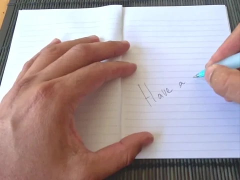 Open notebook, writing handwritten phrases of love and positivity Stock Footage 321018316