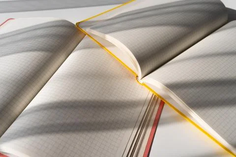 Open Notebooks with Grid Pages and Overlapping Shadows on White Surface Stock Photos