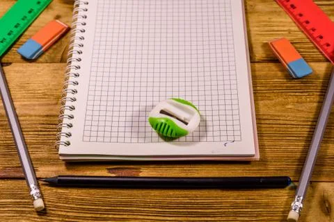 Open notepad and different stationeries on a wooden table Stock Photos
