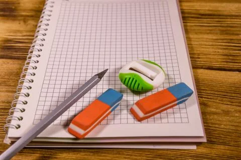 Open notepad and different stationeries on a wooden table Stock Photos