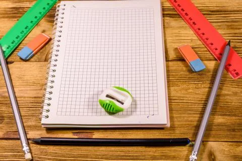 Open notepad and different stationeries on a wooden table 스톡 사진