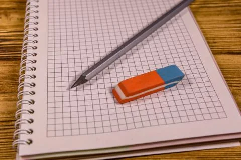Open notepad and different stationeries on a wooden table Stock Photos