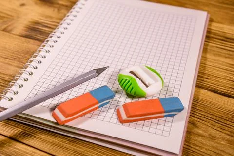 Open notepad and different stationeries on a wooden table Stock Photos