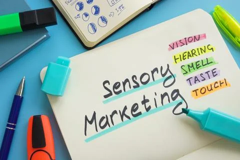 Open notepad and marks about Sensory marketing. Stock Photos
