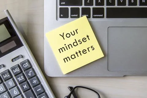 Open notepad and sticky notes with word "your mindset matters" Stock Photos