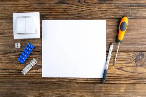 Open Notepad and tools of an electrician installer or Builder on a gray woode Stock Photos