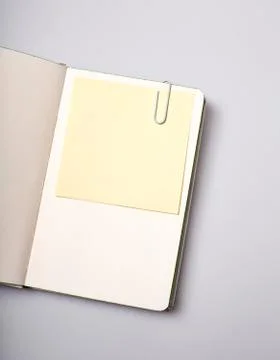 Open notepad blank page with note sticker on white table Stock Photos