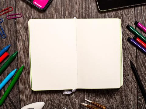 Open notepad with blank pages on table with office tools Stock-Fotos