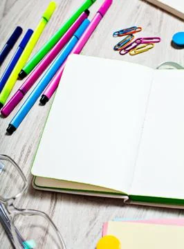 Open notepad with blank pages on table with office tools Stock Photos