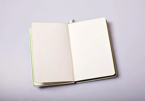 Open notepad with blank pages on white table Foto stock