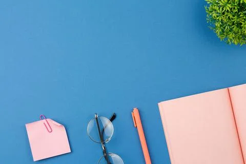 Open notepad with calculator, glasses and pen. Stock Photos