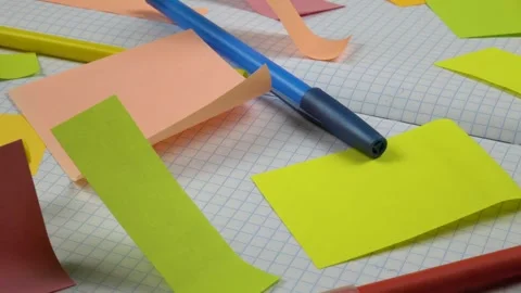 An open notepad with checkered sheets and sticky notes on them Stock Footage 336507363