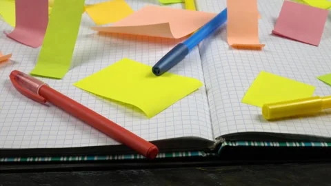 An open notepad with checkered sheets and sticky notes on them Stock Footage 336507388