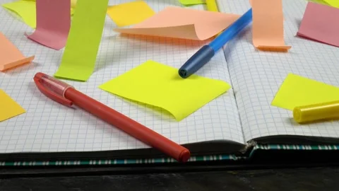 An open notepad with checkered sheets and sticky notes on them Stock Footage 336507415