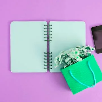 Open Notepad clean pages to record a bouquet of flowers in a paper bag mobile Stock Photos
