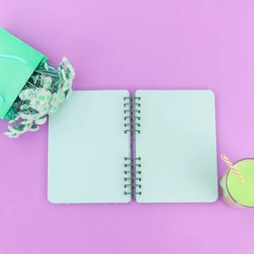 Open Notepad clean pages to write a bouquet of flowers in a paper bag glass c Stock Photos