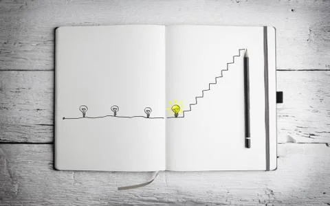 Open notepad with with concept of idea on white wooden table Stock Photos