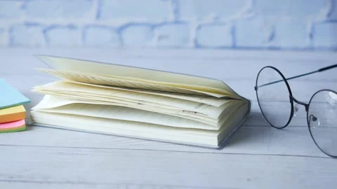 Open notepad , eyeglass and pen on table Stock Footage 160828059