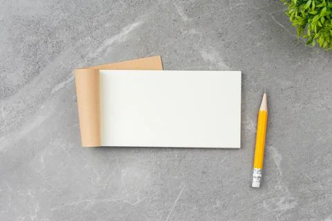 Open notepad on gray marble background. Stock-Fotos