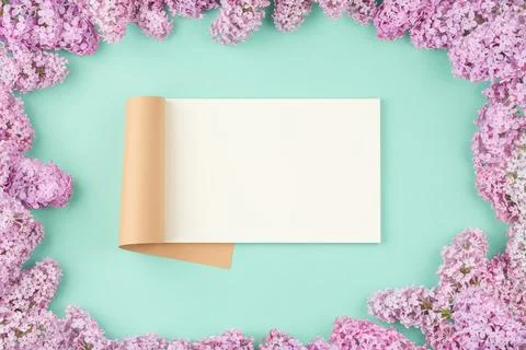 Open notepad with lilac flowers Stock Photos
