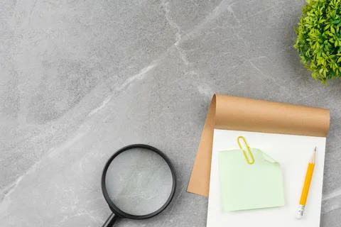 Open notepad office desk on gray marble background Stock Photos