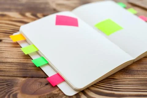 Open notepad with office supplies. Open notepad lies on a wooden desktop Stock Photos