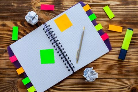 Open notepad with office supplies. Open notepad lies on a wooden desktop Stock Photos