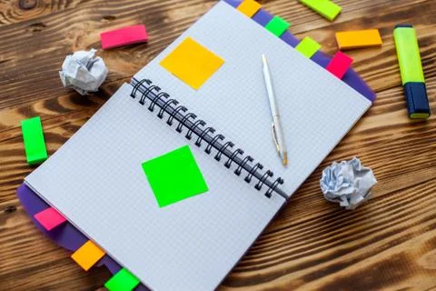 Open notepad with office supplies. Open notepad lies on a wooden desktop Stock Photos
