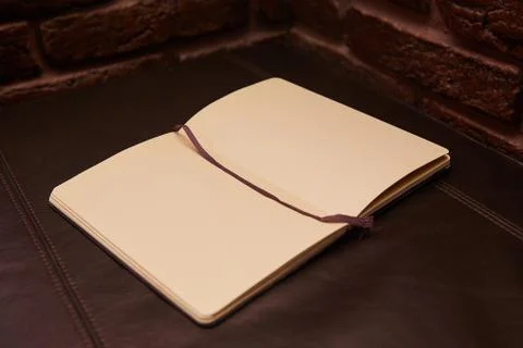 Open Notepad or sketchbook lying on black background Stock Photos