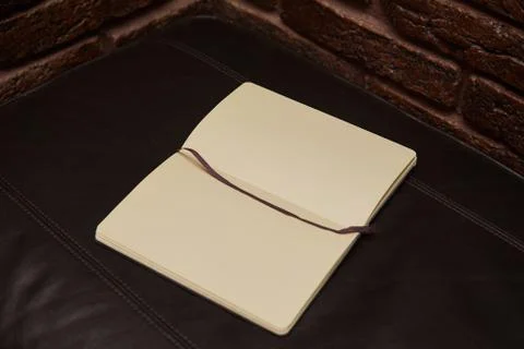 Open Notepad or sketchbook lying on black background Stock Photos