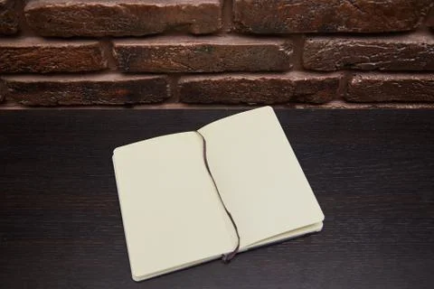 Open Notepad or sketchbook lying on black background Stock Photos